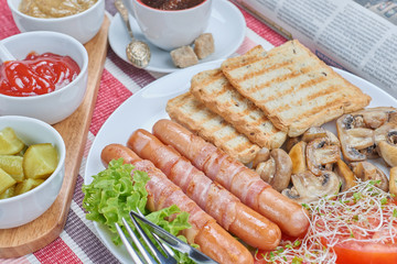 Fried sausages wrapped in bacon