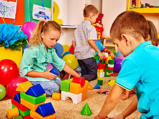Fototapeta na wymiar Group children game blocks on floor in kindergarten . Top view.