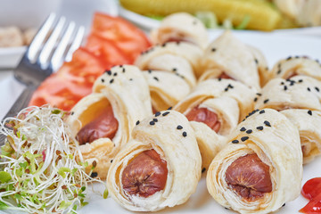 Sausages baked in a puff pastry