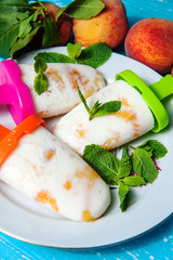 Homemade peach popsicles with mint