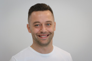 Obraz premium Portrait of young handsome man in white T-shirt