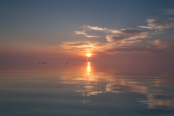 The sun rises over the open sea horizon early, 03:49, during summer time (3:49 am).