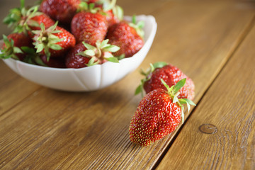 strawberries in white plate on the table
