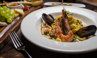 pasta seafood in tomato sauce with shrimp and tomatoes