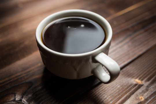 coffee americano with  beans on wooden table