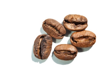 Coffee beans with sharp shadow, isolated macro.