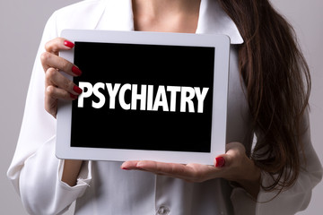 Female doctor holding a tablet with the text: Psychiatry