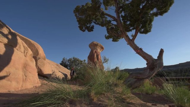 Young Woman Hiker in Devil's Garden Grand Staircase Escalante National Monument slow Trucking