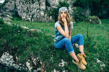 Fashion studio portrait of pretty young hipster blonde woman wit