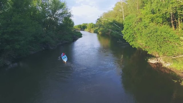 Girl in a blue kayak floating. Aerial video. 4k 30fps