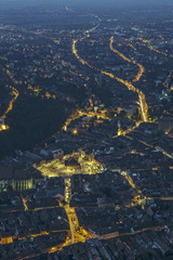 Aerial night city view above the historic center of Brasov city, Romania.