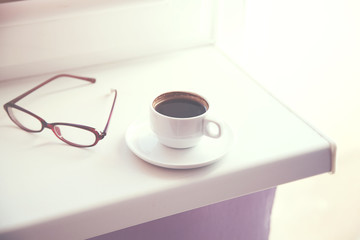 coffee and glasses on window