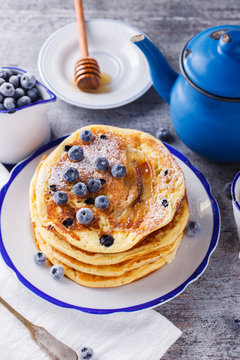 Pancake with banana , blueberries and honey.
