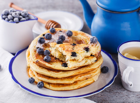 Pancake with banana , blueberries and honey.