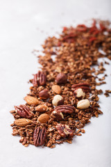 Granola with nuts,Goji berries, and honey,scattered on the table.Healthy dry Breakfast.Healthy food or diet concept.selective focus.