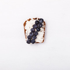 Sweet sandwich with cream-cheese blueberries over a white background . Top view. healthy breakfast.Copy space.selective focus.
