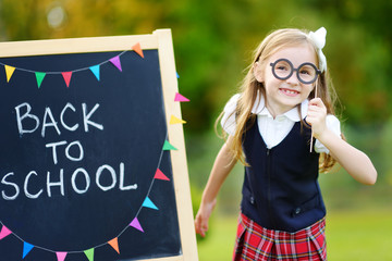 Cute little schoolgirl feeling excited about going back to school