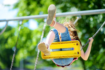 Cute little girl having fun on a playground © MNStudio