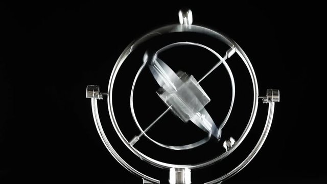 Close up of Newton's Cradle, Desk toy pendulum being activated, black background