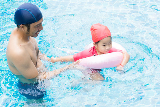 Pretty little asian girl in swimming pool