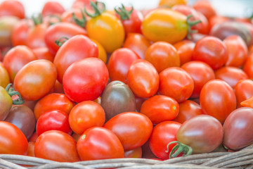 fresh tomatoes in basket, Close-up view group of fresh tomatoes.