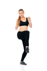 Fitness woman doing stretching exercise, full length portrait isolated over white background