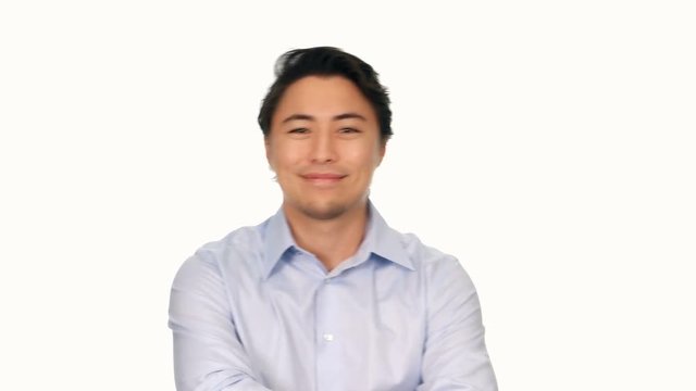 Trendy Attractive Man Wearing A Light Blue Shirt, Smiling And Walking Towards Camera In Front Of A White Background. 