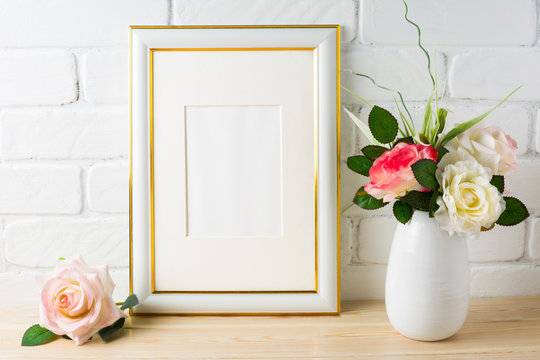 White frame mockup on brick wall with roses