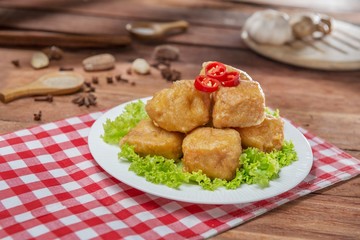 Plate of fried fish balls with cabbage on the table in restaurant