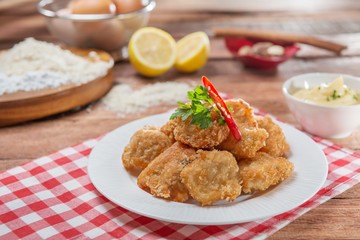 Plate of fried breaded pork on the table in restaurant