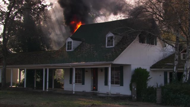 Burning interior seen through windows of house on fire