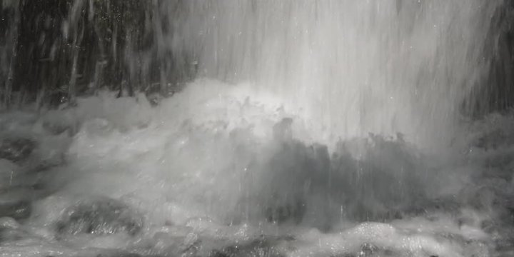 Close-up churning water at the foot of a falls
