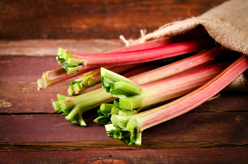 fresh organic red rhubarb on wooden table, Rustic style