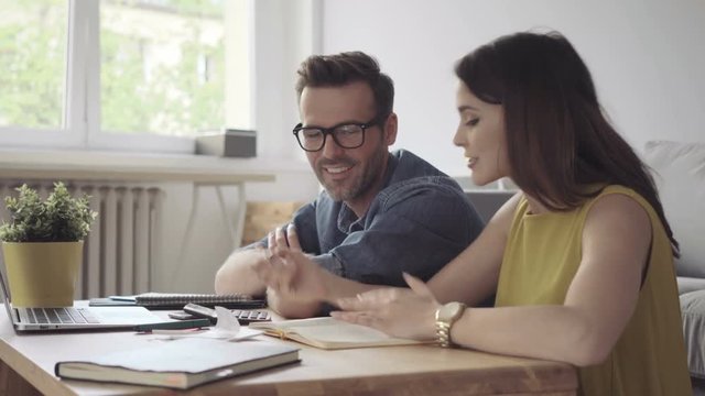 Happy couple counting bills - home finance concept