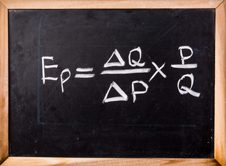 economics equation on blackboard