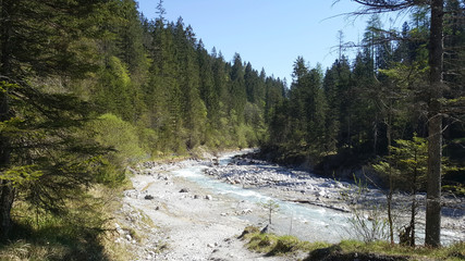 Beautiful clear river at the valley of Wimbachgries with blue sky background