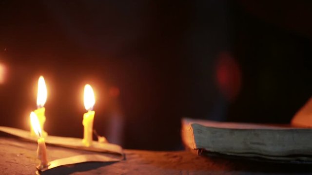 witch holding the magic ritual. old book and candle. halloween