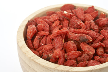 goji berry in wooden cup on white background.