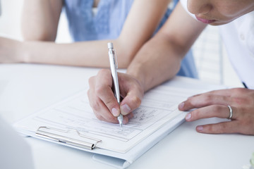 Husband is fill in the medical record in the hospital