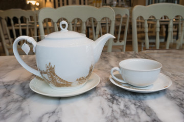 Hot tea set with glass cup and glass pot on marble table