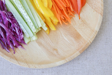Go green, Rainbow salad on wooden plate
