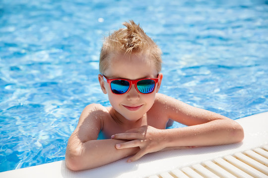 portrait of young caucasian boy in swimming pool