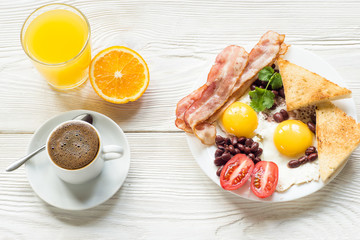 English breakfast with bacon, fried egg, baked beans