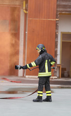 Firefighter with hose fighting services