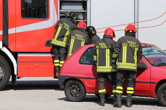 italian firefighters in action during a car accident