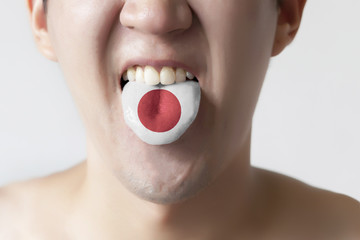 Japan flag painted in tongue of a man - indicating Japanese language speaking