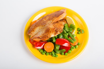 Fried fish fillet with vegetable garnish