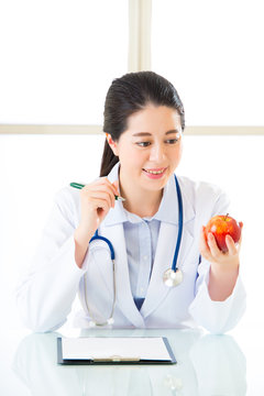 Young asian nutritionist doctor writing diet plan