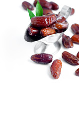 Dates in a bowl on white background.