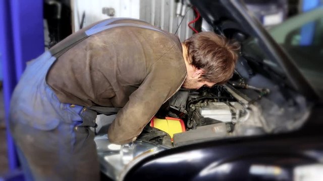 auto mechanic man changing air filter